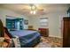 Charming bedroom featuring blue walls, unique floor tiles, built-in shelves, and a ceiling fan at 7699 92Nd St, Seminole, FL 33777
