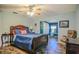 Bright bedroom with blue walls, tile floors, a ceiling fan, and an adjacent office space at 7699 92Nd St, Seminole, FL 33777
