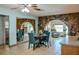 Dining room with unique stone archway, stone accent wall, round table, and turquoise dining chairs at 7699 92Nd St, Seminole, FL 33777