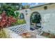 Unique brick-paved entrance with an arched walkway surrounded by colorful plants at 7699 92Nd St, Seminole, FL 33777