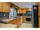 Well-equipped kitchen with stainless steel appliances, light wood cabinets, and tiled backsplash at 7699 92Nd St, Seminole, FL 33777