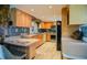 Spacious kitchen featuring light wood cabinetry, stainless steel appliances, and stone accents at 7699 92Nd St, Seminole, FL 33777
