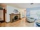 Cozy living room featuring a brick fireplace, tile flooring, and comfortable seating at 7699 92Nd St, Seminole, FL 33777