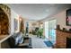 Open living area with a stone archway and sliding glass doors leading to the pool at 7699 92Nd St, Seminole, FL 33777