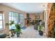 Bright living room with tile floors, a brick fireplace, and sliding glass doors to the outside at 7699 92Nd St, Seminole, FL 33777