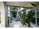 Covered patio with a white picnic table and potted plants, great for outdoor relaxation at 7699 92Nd St, Seminole, FL 33777
