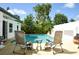 Backyard showcasing a refreshing in-ground pool with lounge chairs for relaxing by the water at 7699 92Nd St, Seminole, FL 33777