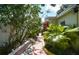 Landscaped side yard path showcases lush greenery and colorful plants along the house at 7699 92Nd St, Seminole, FL 33777