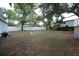 Expansive backyard with lush greenery, complemented by a white fence, providing a serene outdoor retreat at 8405 N Willow Ave, Tampa, FL 33604