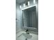 Bathroom featuring a large mirror, contemporary lighting, and quartz countertop at 8405 N Willow Ave, Tampa, FL 33604