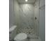 Bathroom featuring a marble-tiled shower and patterned floor at 8405 N Willow Ave, Tampa, FL 33604