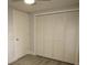 Bedroom closet featuring bi-fold doors and wood-look floors at 8405 N Willow Ave, Tampa, FL 33604