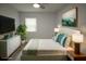 Tastefully staged bedroom with plants, mounted television, and artwork at 8405 N Willow Ave, Tampa, FL 33604