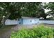 Light blue single-Gathering home with a brick walkway and well-maintained front yard at 8405 N Willow Ave, Tampa, FL 33604