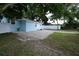 Landscaped yard, light blue exterior of a charming single-Gathering home at 8405 N Willow Ave, Tampa, FL 33604