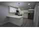 Modern kitchen featuring stainless steel appliances, white cabinets, and a breakfast bar at 8405 N Willow Ave, Tampa, FL 33604