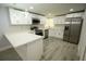 Modern kitchen featuring stainless steel appliances, white cabinets, and a breakfast bar at 8405 N Willow Ave, Tampa, FL 33604