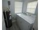 Laundry room includes a water heater, washer, and dryer at 8405 N Willow Ave, Tampa, FL 33604