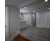 Open living area showcasing the light gray paint, modern vinyl floors, white trim, and recessed lighting at 8405 N Willow Ave, Tampa, FL 33604