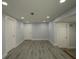 Spacious living room with recessed lighting, white doors, and gray flooring at 8405 N Willow Ave, Tampa, FL 33604