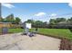 Spacious backyard with patio seating, lush green grass, storage shed, and wood fence at 8939 90Th Ave, Seminole, FL 33777