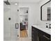 This bathroom includes a stand-up shower, vanity and view into the living room at 8939 90Th Ave, Seminole, FL 33777