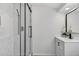 Modern bathroom features glass shower with stylish fixtures and vanity with great storage at 8939 90Th Ave, Seminole, FL 33777