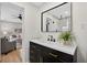 This bathroom features a large mirror, vanity with drawers, modern fixtures and plants at 8939 90Th Ave, Seminole, FL 33777