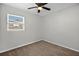 This bedroom features a ceiling fan, neutral walls, and carpet floors at 8939 90Th Ave, Seminole, FL 33777