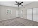 Bedroom features carpet, closet, door to bathroom and view of the backyard at 8939 90Th Ave, Seminole, FL 33777