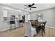 Modern dining area featuring stylish chairs, an elegant ceiling fan, and seamless flow to the kitchen at 8939 90Th Ave, Seminole, FL 33777