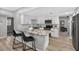 Bright, open kitchen featuring white cabinets, a stylish island with seating, and stainless steel appliances at 8939 90Th Ave, Seminole, FL 33777