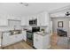 Updated kitchen featuring white cabinets, stainless steel appliances, sleek hardware, and stone countertops at 8939 90Th Ave, Seminole, FL 33777