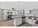 Bright kitchen featuring white cabinets, stone counters, stainless steel appliances, and a connected dining area at 8939 90Th Ave, Seminole, FL 33777