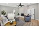 Cozy living room featuring a stone fireplace, comfortable seating, modern lighting, and an open layout at 8939 90Th Ave, Seminole, FL 33777