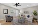 Bright living room features stylish decor, ceiling fan, and wood-look flooring at 8939 90Th Ave, Seminole, FL 33777