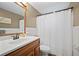 Well-lit bathroom featuring a single sink vanity and a shower/tub combo at 903 Dixie Maid Ln, Valrico, FL 33594