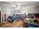 Well-lit bedroom with laminated floor and a ceiling fan at 903 Dixie Maid Ln, Valrico, FL 33594