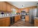 Bright kitchen featuring custom wood cabinetry, stainless steel appliances, and modern countertops at 903 Dixie Maid Ln, Valrico, FL 33594