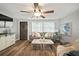 Cozy living room with wood-look floors, ceiling fan, and neutral décor at 903 Dixie Maid Ln, Valrico, FL 33594