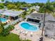 Aerial view of a landscaped backyard featuring an in-ground kidney-shaped pool and lounge chairs for relaxation at 9109 134Th Way, Seminole, FL 33776