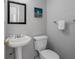 Bathroom with pedestal sink, standard toilet, and minimalist wall decor at 9109 134Th Way, Seminole, FL 33776