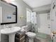 Bathroom with shower, vanity and additional storage over the toilet at 9109 134Th Way, Seminole, FL 33776