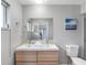 Bathroom featuring a dual sink vanity with modern cabinetry and a large mirror at 9109 134Th Way, Seminole, FL 33776