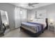 Well-lit bedroom with a ceiling fan, large mirror, and a full bookshelf at 9109 134Th Way, Seminole, FL 33776
