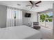 Bright bedroom with a ceiling fan, TV, and a view of the backyard pool and patio at 9109 134Th Way, Seminole, FL 33776