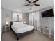 Bright bedroom featuring a ceiling fan, lamps, and a mounted TV at 9109 134Th Way, Seminole, FL 33776