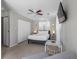 Bedroom with a ceiling fan, lamps, mounted TV, and a large closet at 9109 134Th Way, Seminole, FL 33776