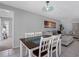 Dining room and living room showing open concept living. Table has seating for four at 9109 134Th Way, Seminole, FL 33776