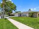 Charming single-story home with a well-manicured lawn and stone accents at 9109 134Th Way, Seminole, FL 33776